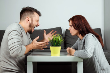 Husband and wife scream at each other, close-up. Family quarrel, showdown, division of property, divorce. The struggle between women and men.