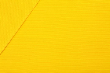 Yellow cotton textile - close up of fabric texture. Cotton Fabric Texture. Top View of Cloth Textile Surface. Yellow Clothing Background. Text Space. Abstract background and texture for designers.