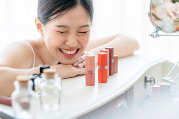 Wall Mural - beautiful asian woman white tshirt smile with happiness hand pick makeup cosmetic items powder table with healthy face skincare concept