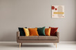 © Photographee.eu - Abstract painting on grey wall of retro living room interior with beige sofa with pillows
