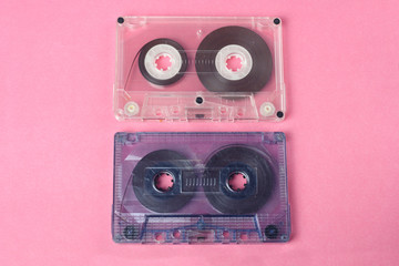 group of two audio retro vintage cassette tape 80s style on pink background