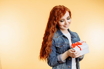 Portrait of a happy smiling girl holding present box