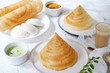 South Indian breakfast cone shaped dosa Idli sambar and chtney background