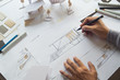 © Chaosamran_Studio - architect design working drawing sketch plans blueprints and making architectural construction model in architect studio