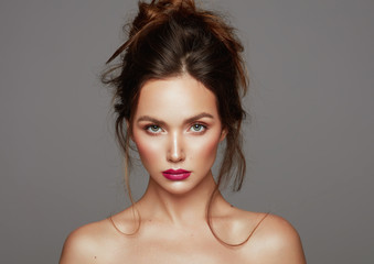 Portrait of young girl with clean fresh skin face isolated over gray background