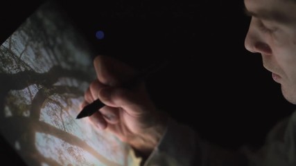 Wall Mural - professional creative digital artist photographer editing his artwork on interactive tablet computer