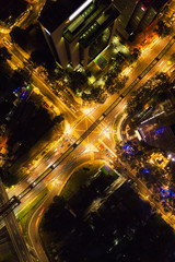 Poster - Aerial view of highway junctions shape letter x cross at night. Bridges, roads, or streets in transportation concept. Structure shapes of architecture in urban city, Kuala Lumpur Downtown, Malaysia