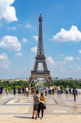 Wall Mural - Young couple admiring view of Eiffel tower, Paris, France