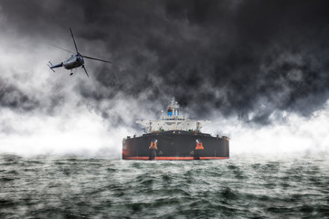 A helicopter rescue mission in difficult stormy weather at sea.