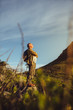 © Jacob Lund - Hiker standing on a hill looking at the hills around