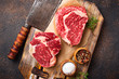 Raw marbled ribeye steak and butchers knife