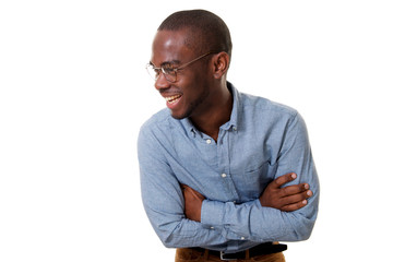 Wall Mural - young african american businessman with glasses laughing with arms crossed against isolated white background
