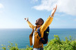 © mimagephotos - happy young african american male traveler with arms open outdoors