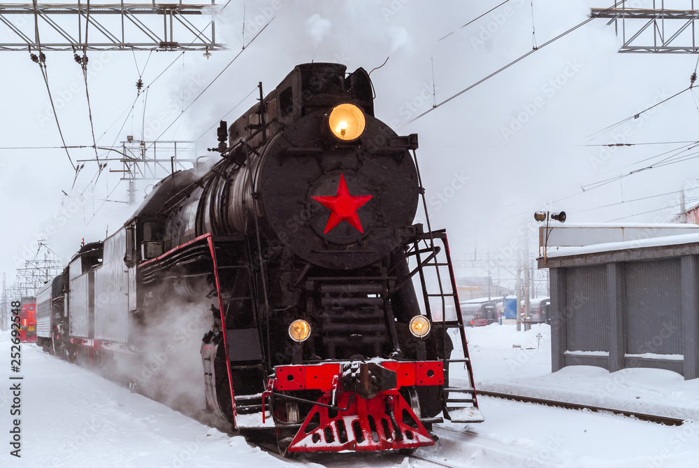 steam locomotive at the station in winter - obrazy, fototapety, plakaty 