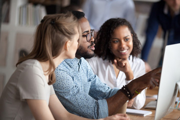 Black team leader working together with females colleagues on project