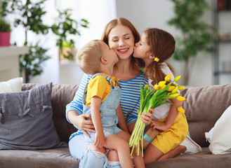 Sticker - Happy mother's day! Children congratulates moms and gives her a gift and flowers .