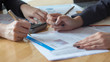 © Adisorn - Two business people talking and analysis about finance on table in office,  financial and accounting concept.