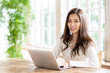 © taka - attractive asian woman using laptop in living room