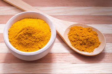 Wall Mural - Turmeric powder on wooden background