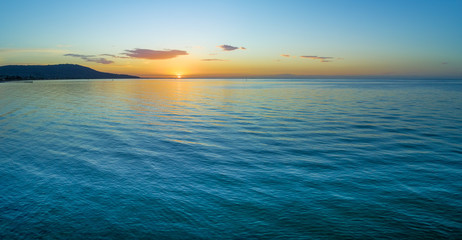 Water and land at dusk - minimalist aerial seascape panorama with copy space