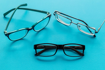 Canvas Print - Accessories for eyes. Glasses with transparent lenses and different frames on blue background