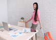© weedezign - Asian woman holding travel suitcase leaving from work on table and prepare to holiday vacation.out of office concept.