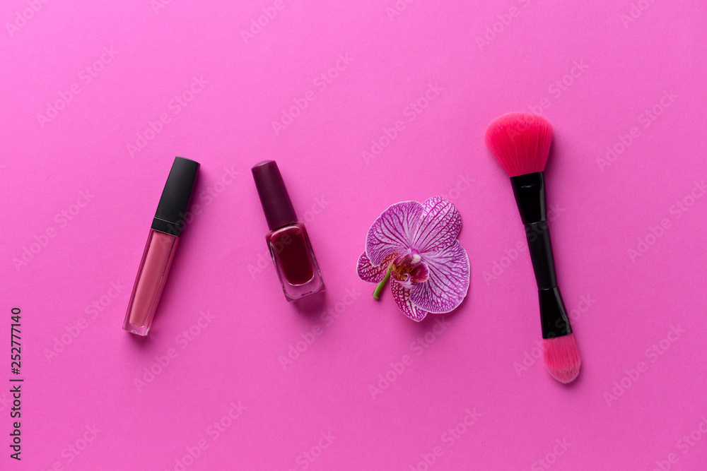 Composition with cosmetics and orchid flower on color background