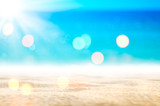Fototapeta Morze - Blur tropical beach with bokeh sun light wave abstract background.