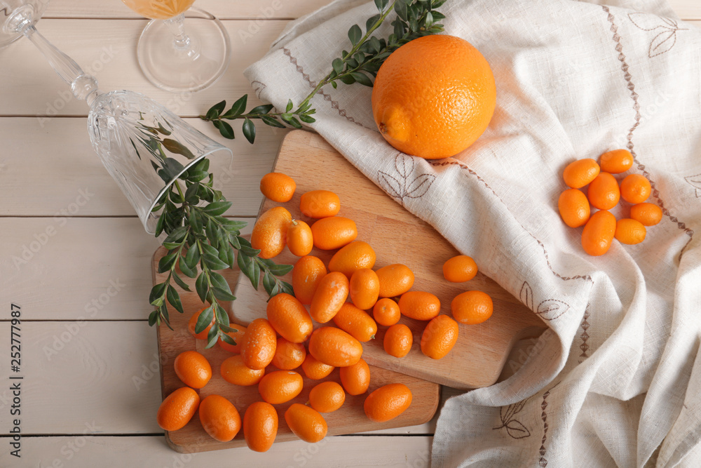 Delicious kumquat fruit and orange on table