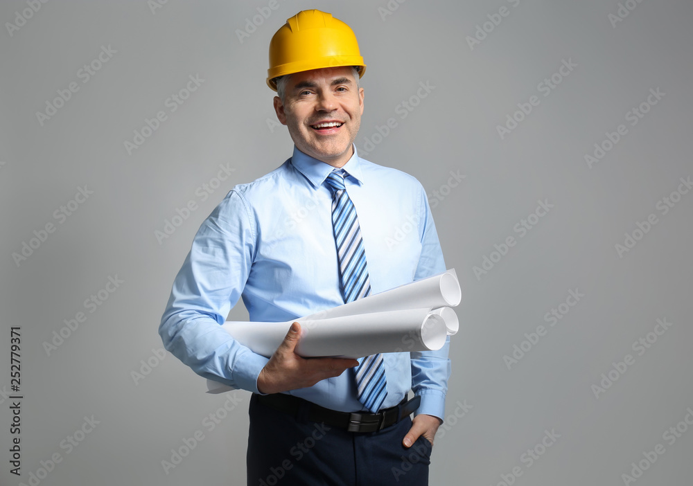 Mature architect on grey background
