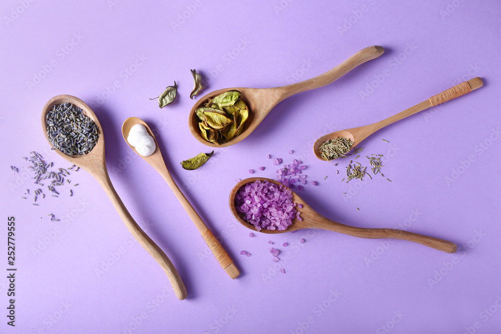 Spoons with natural ingredients for cosmetic on color background