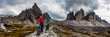 Cycling woman and man riding on bikes in Dolomites mountains andscape. Couple cycling MTB enduro trail track. Outdoor sport activity.