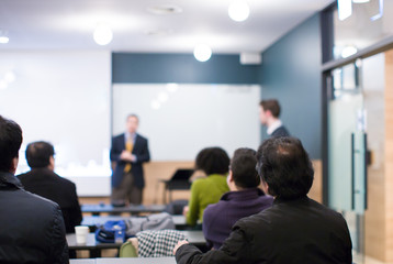 Wall Mural - Speaker at Talk in Business Conference. Executive Speaker Entrepreneur on Stage Conference Photo. Business Presentation Presenter Speech at Tech Meeting. Corporate Forum Event for Investor Audience.