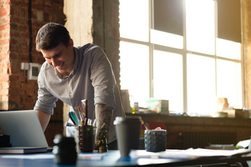 Wall Mural - A man in a modern office works at the computer