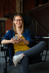 Wall Mural - Portrait of a girl with a phone in a modern office