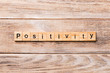 positivity word written on wood block. positivity text on wooden table for your desing, concept