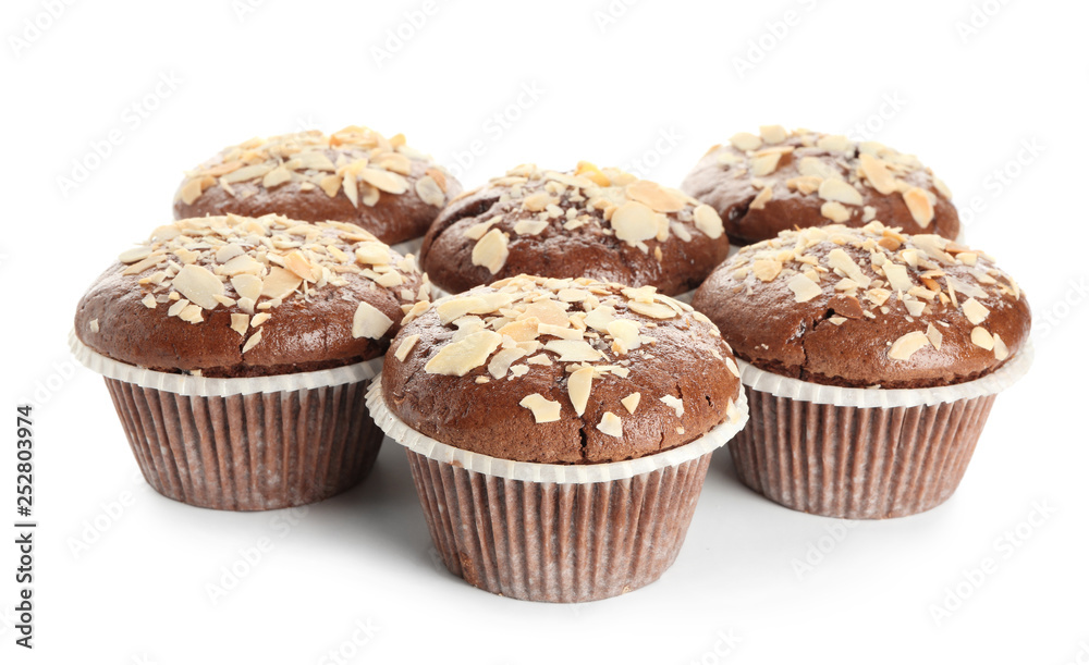 Tasty almond muffins on white background