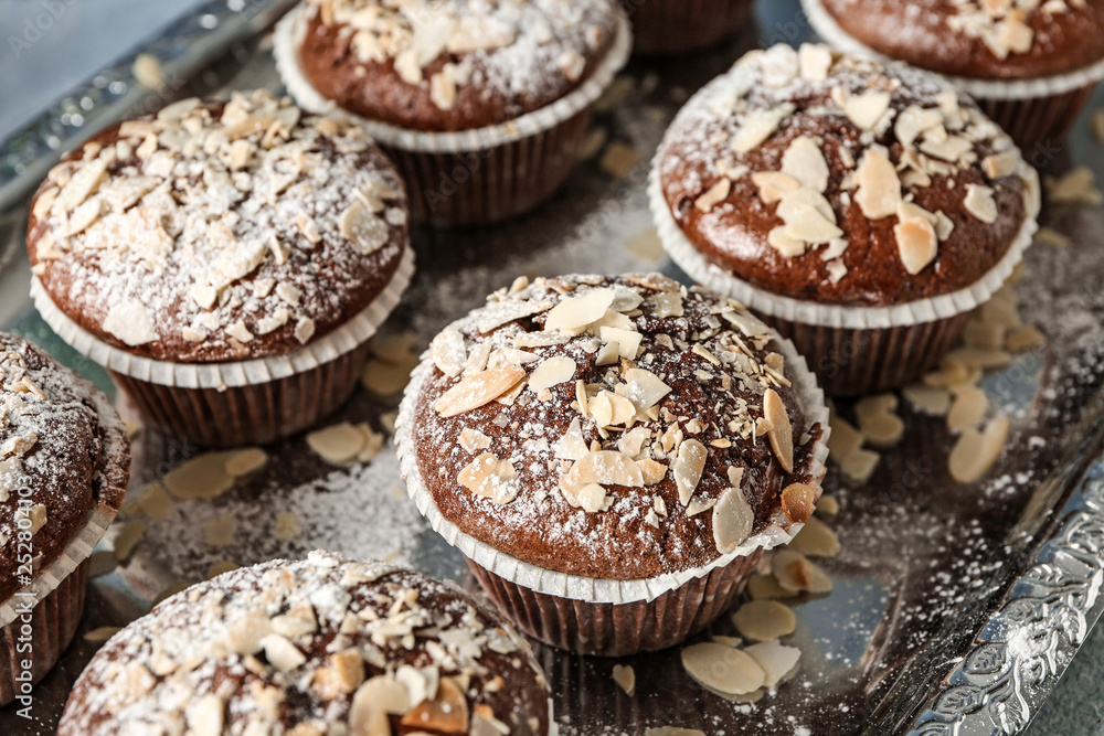 Tasty almond muffins on tray, closeup