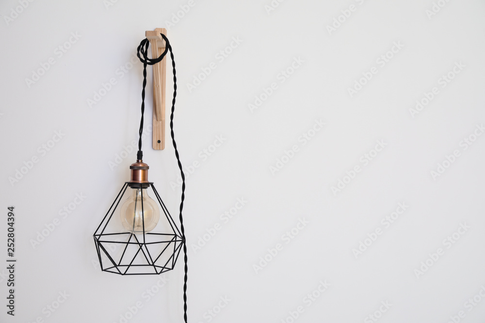 New lamp hanging on white wall