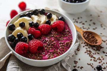 Bowl with tasty acai smoothie on light table