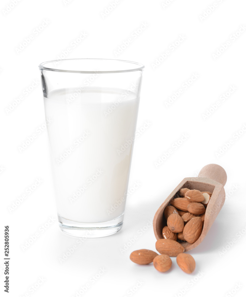 Glass of almond milk on white background