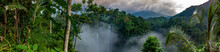 Aerial Over Sekumpul Waterfall Surrounded By Dense Rainforest And Mountains Shrouded In Mist At Sunrise, Bali, Indonesia Panoramic