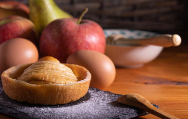 Poster - homemade apple pie on a wooden table with fruit in the background