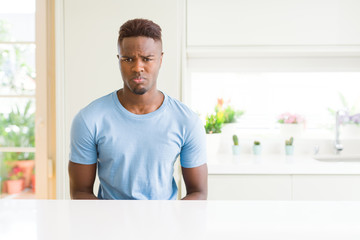 Sticker - Handsome african american man wearing casual t-shirt at home depressed and worry for distress, crying angry and afraid. Sad expression.