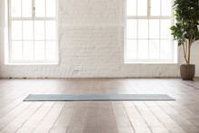 Yoga Mat On Natural Wooden Floor In Empty Room