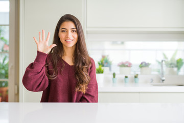 Sticker - Young beautiful woman at home showing and pointing up with fingers number five while smiling confident and happy.