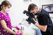 © F8  \ Suport Ukraine - Close up of young man dentist taking picture of mouth, his work on teeth of female patient in dental office.
