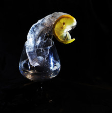 Photo Of Lemon And Ice In Yellow And Black Colors In Wineglass Which Can Be Good Illustration And Beautiful Abstract Picture