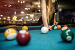 © RomanR - Selective focus at billiard ball on blue table
