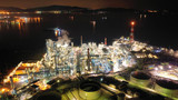Fototapeta Przestrzenne - Aerial drone night shot of industrial oil refinery plant with dazzling lights